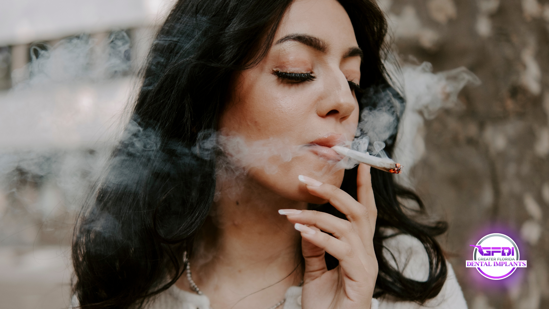 Woman exhales smoke from a lit cigarette, set against a blurred background.