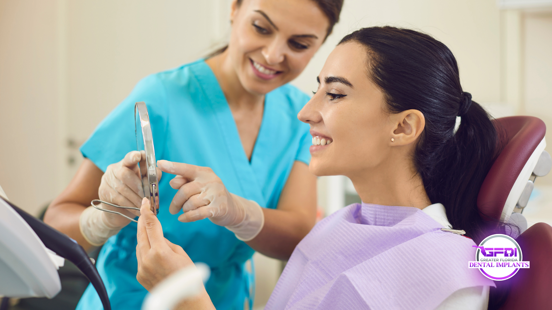Dental assistant showing tools to a smiling patient in a clinic chair