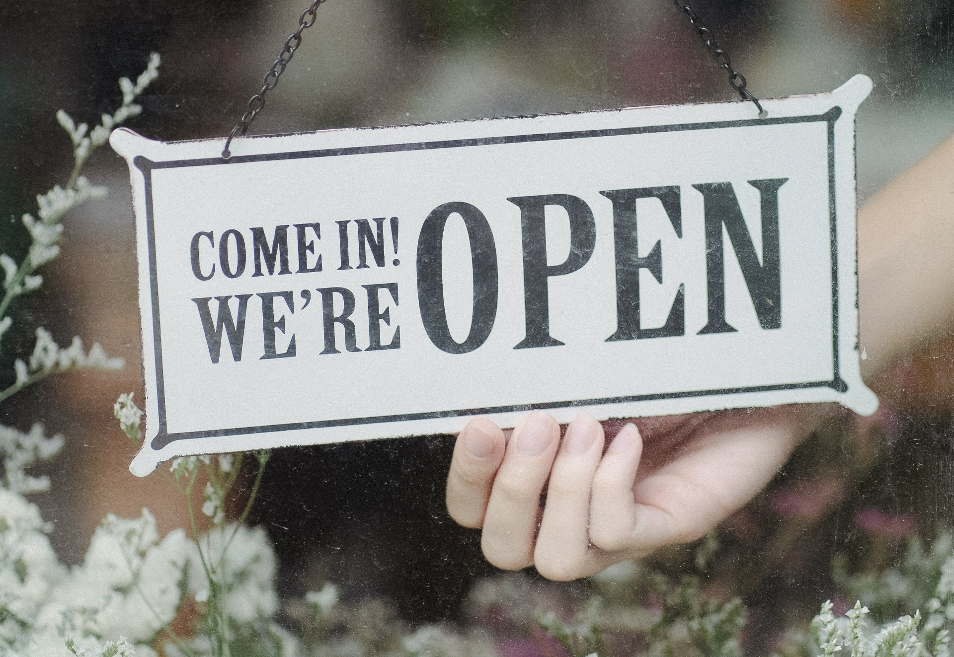 sign that reads come in we're open