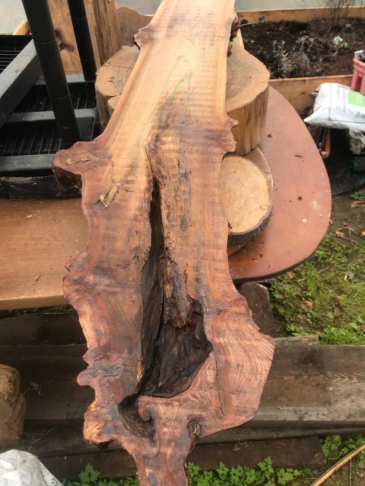 A piece of wood is sitting on top of a wooden table.