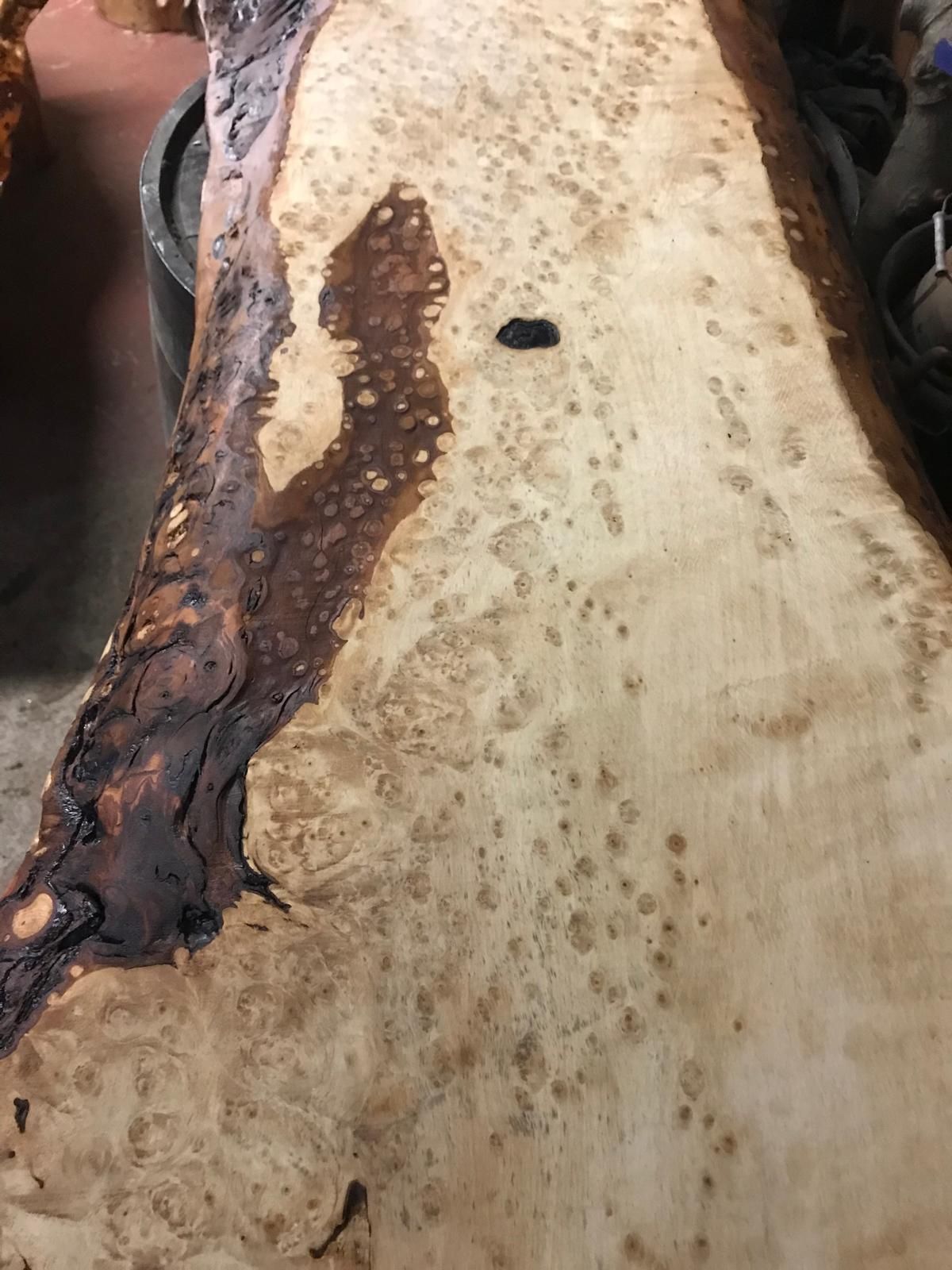 A close up of a piece of wood with a hole in it.
