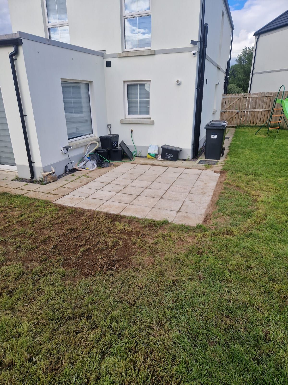 There is a patio in the backyard of a house.