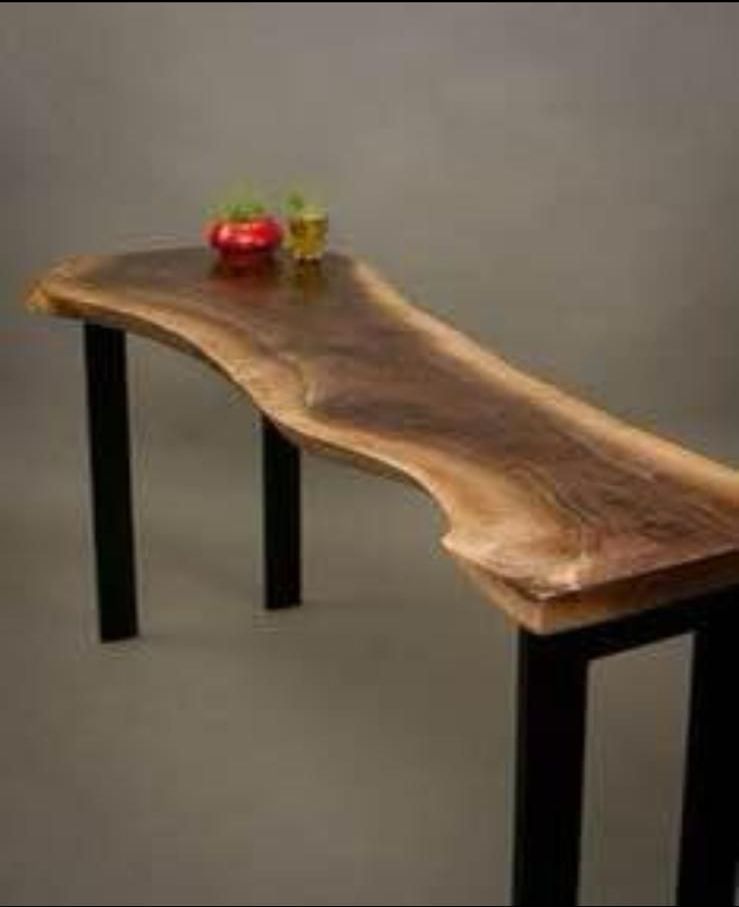 A wooden table with two vases on top of it.
