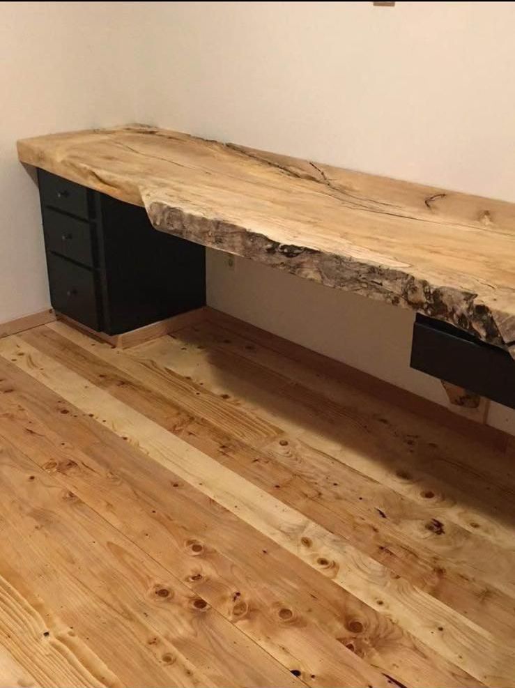 A wooden desk with a wooden floor in a room.