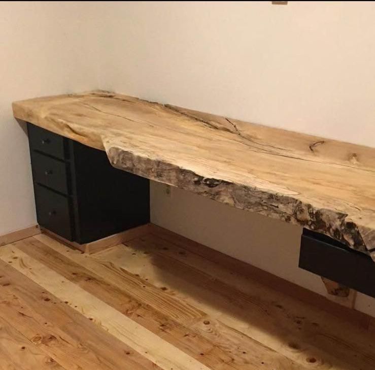 A wooden desk with a black drawer underneath it