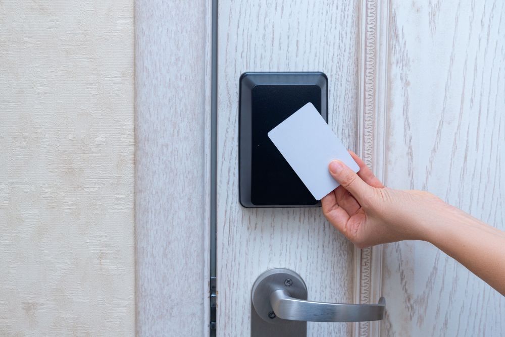 A person is using a smart card to open a door.