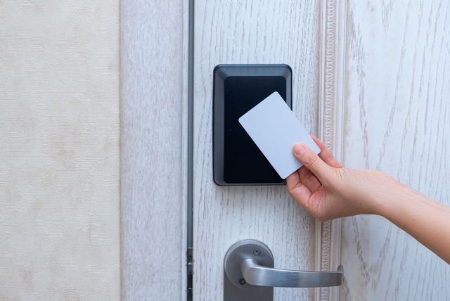 A person is using a smart card to open a door.