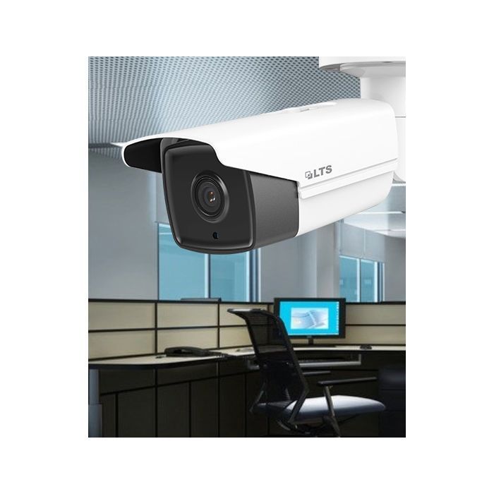 A security camera is hanging from the ceiling in an office