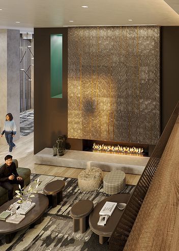A modern lounge features a large stone fireplace, neutral seating, a patterned area rug, and an open balcony view.