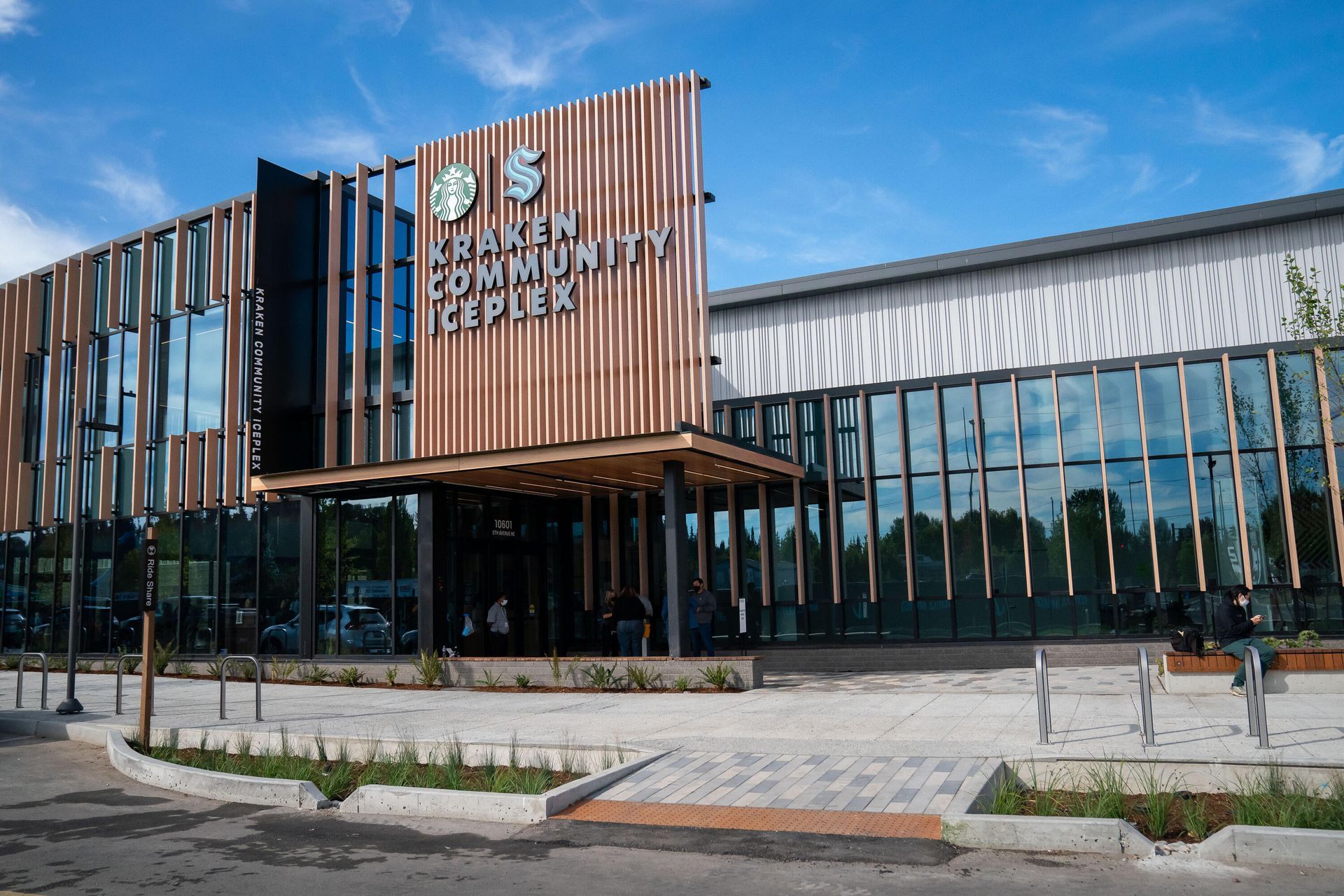 The Kraken Community Iceplex exterior building with modern glass, steel, and vertical wood-slat architectural features.