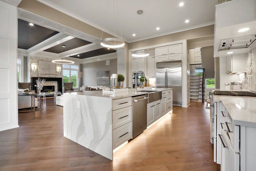 A large kitchen with white cabinets and stainless steel appliances
