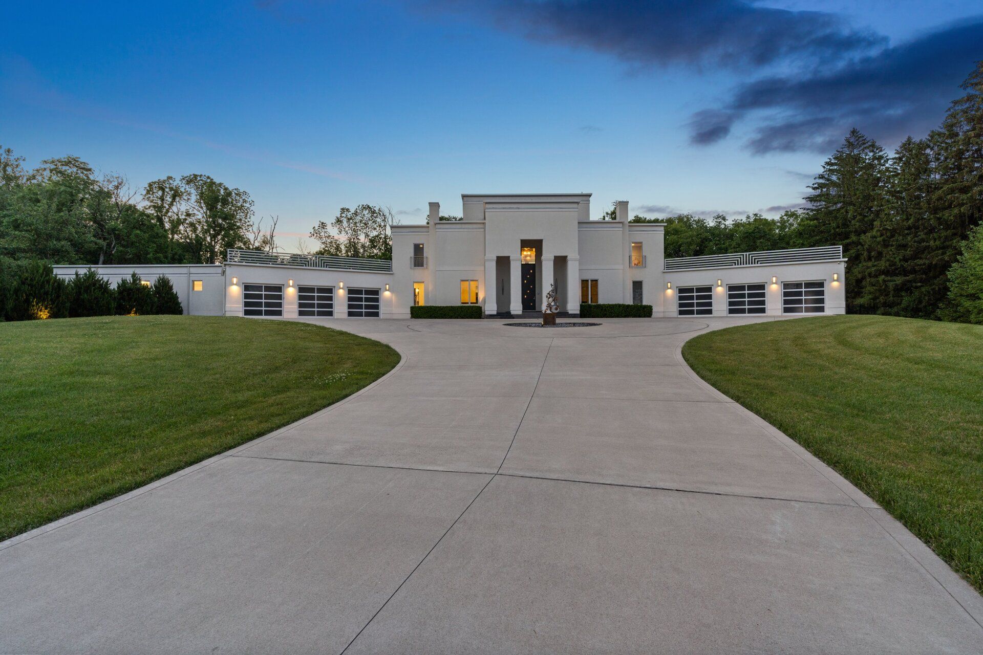 A large white house with a driveway leading to it