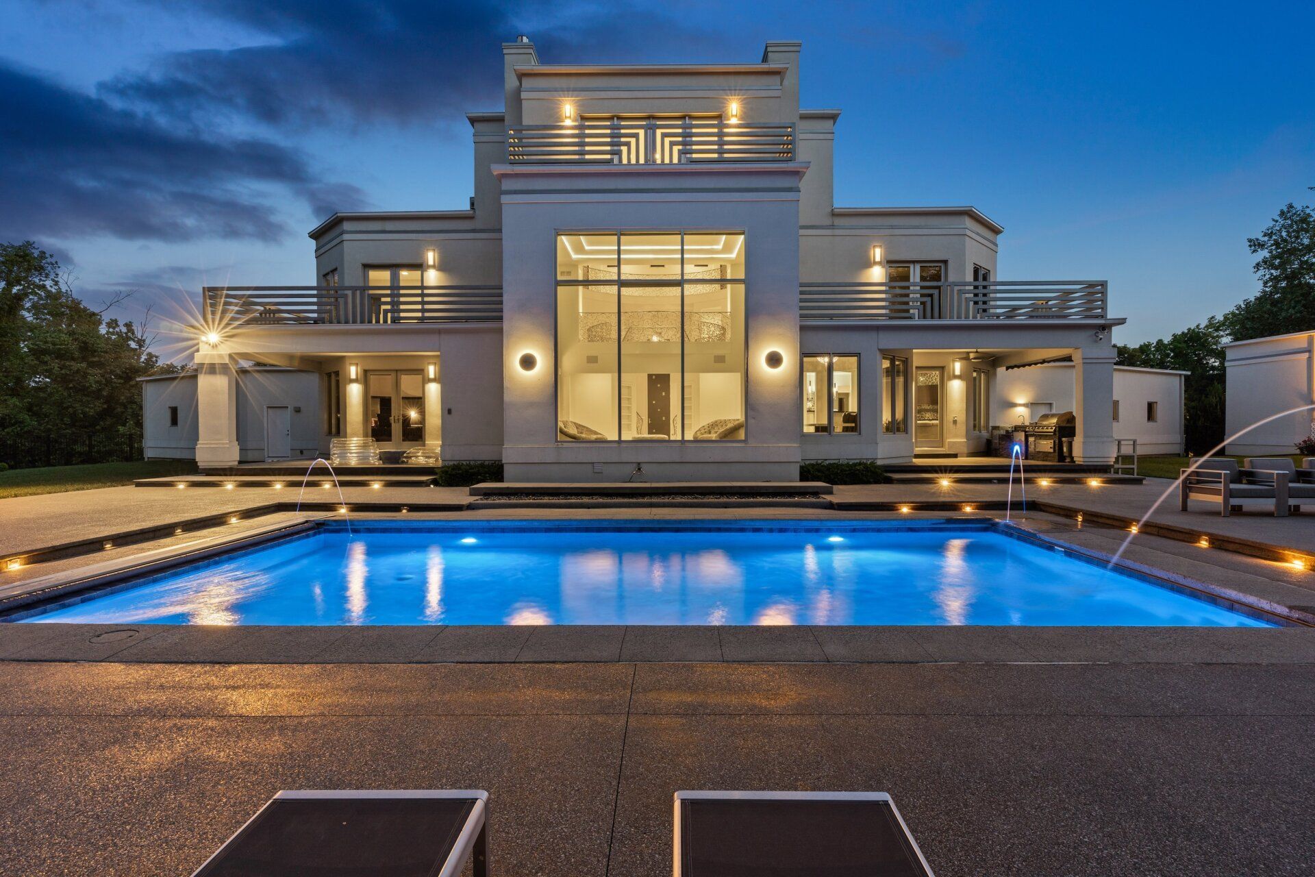 A large house with a large swimming pool in front of it