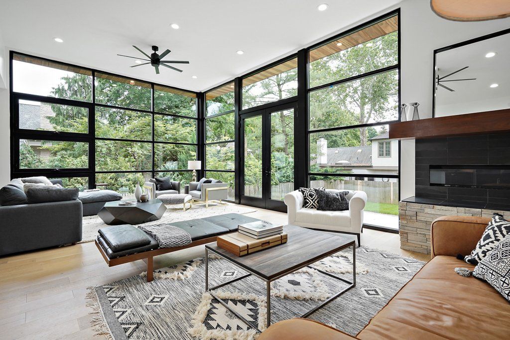 A living room with a lot of windows and furniture