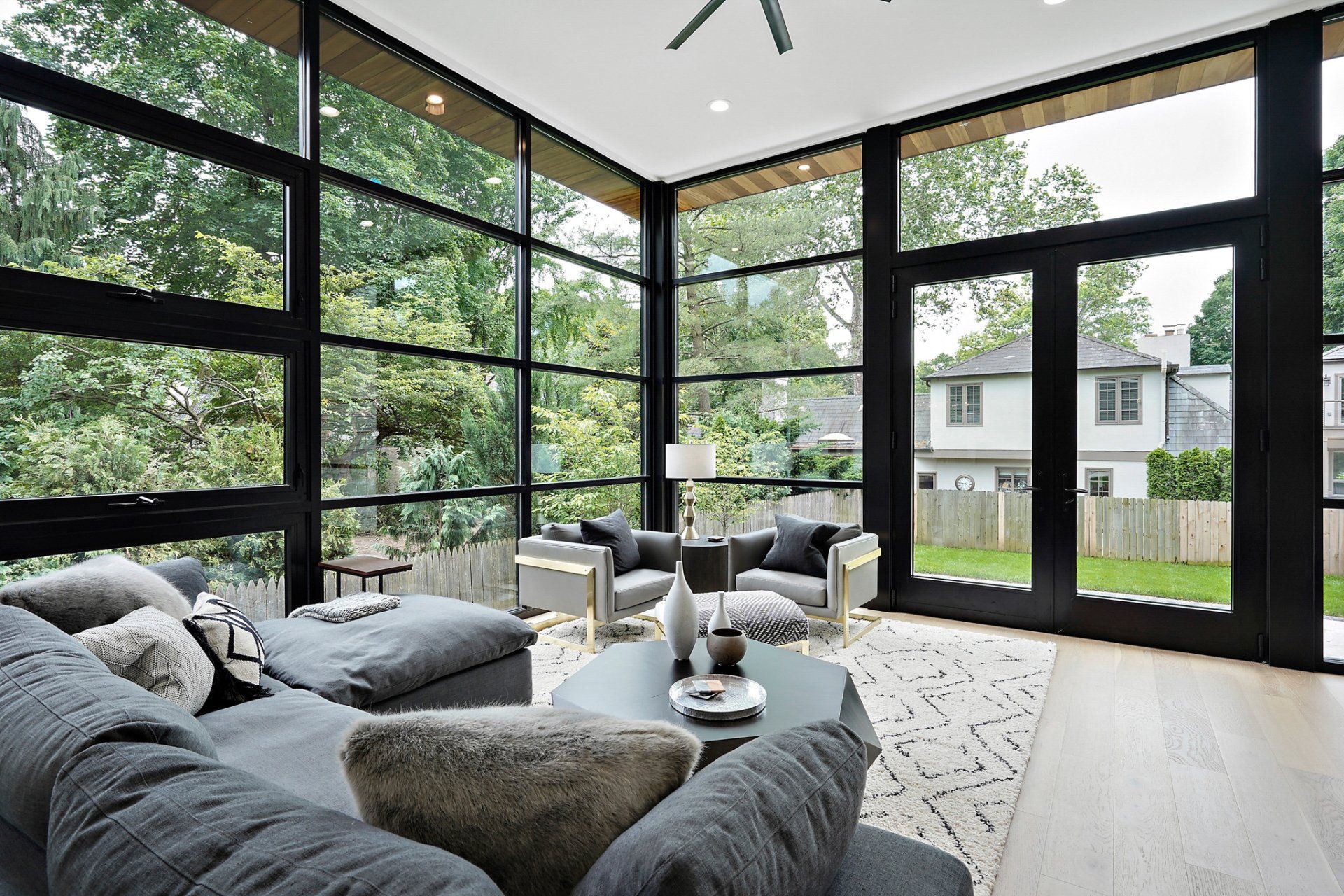 A living room with a lot of windows and furniture