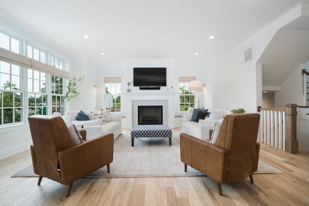 A living room with a fireplace and a flat screen tv