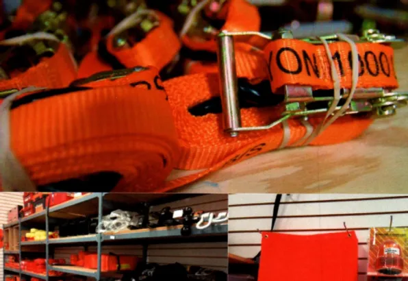 Orange ratchet straps with metal buckles, a store shelf with tools, and a red flag.