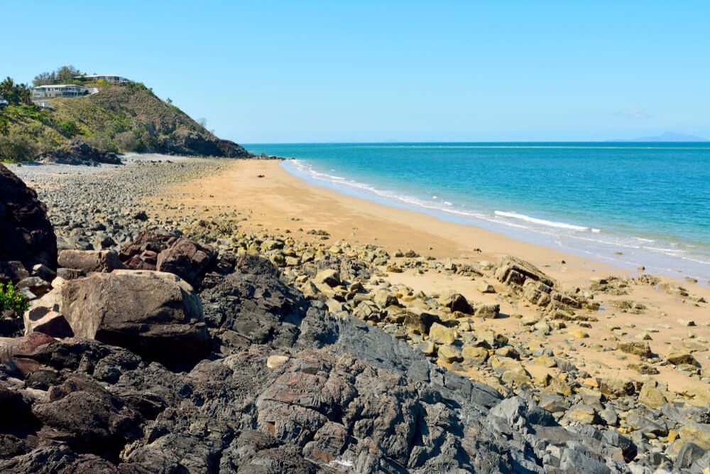 A Rocky Beach With A Large Rock In A Large Body Of — Dieselflash Whitsundays in Mackay, QLD