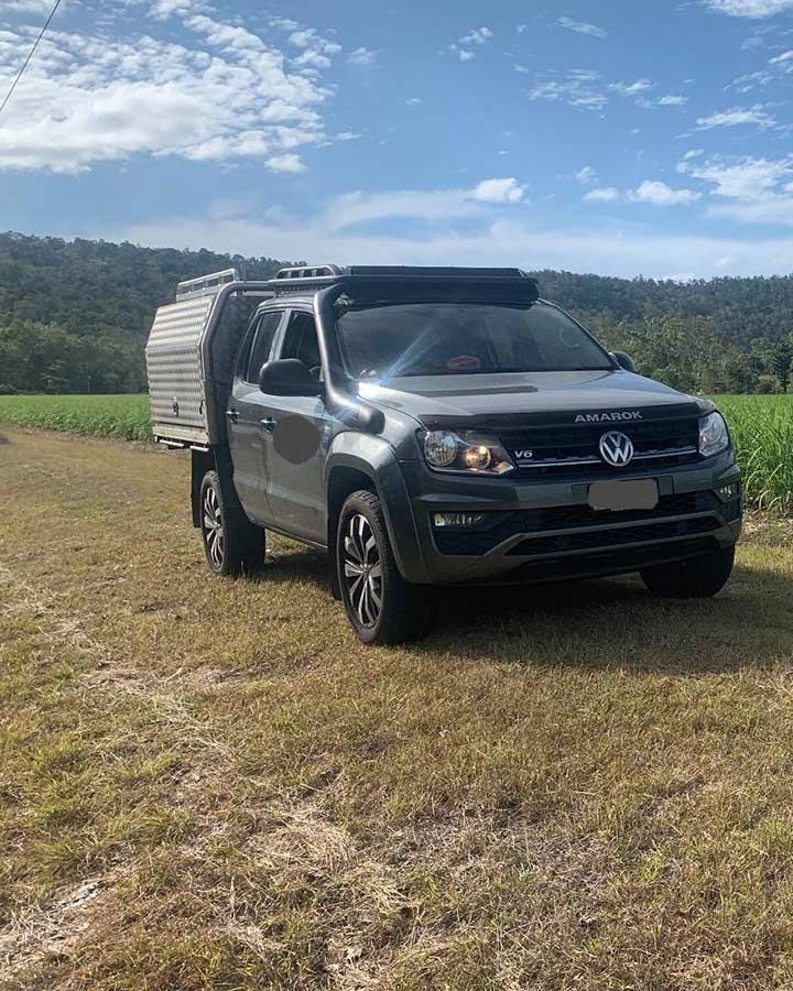 A Volkswagen Amarok Is Parked In A Grassy Field — Dieselflash Whitsundays in Airlie Beach, QLD