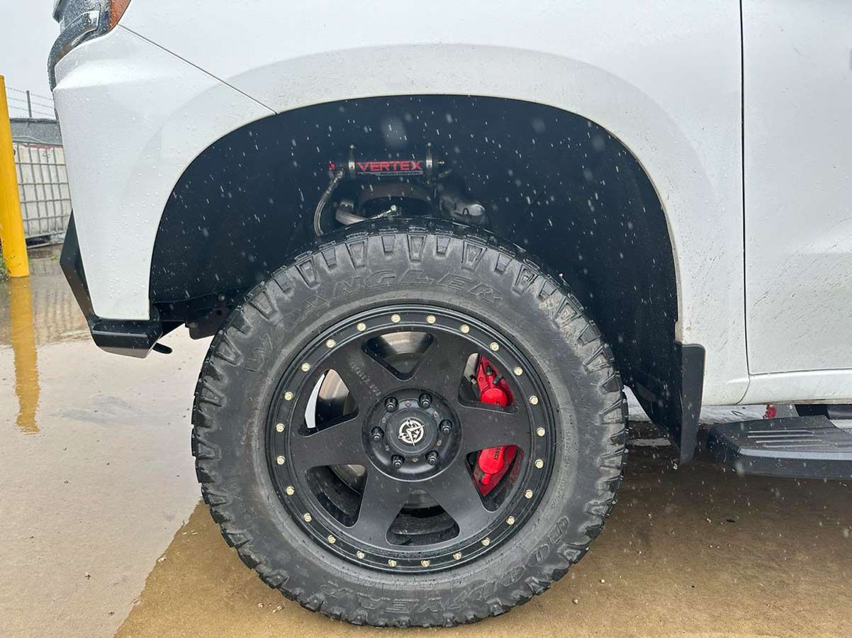 A White Truck With Black Wheels And Red Brake Calipers — Dieselflash Whitsundays in Airlie Beach, QLD