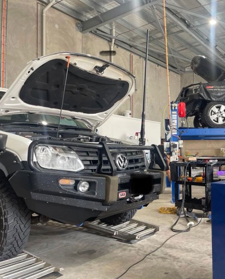 A White Truck With The Hood Open Is Parked In A Garage — Dieselflash Whitsundays in Airlie Beach, QLD