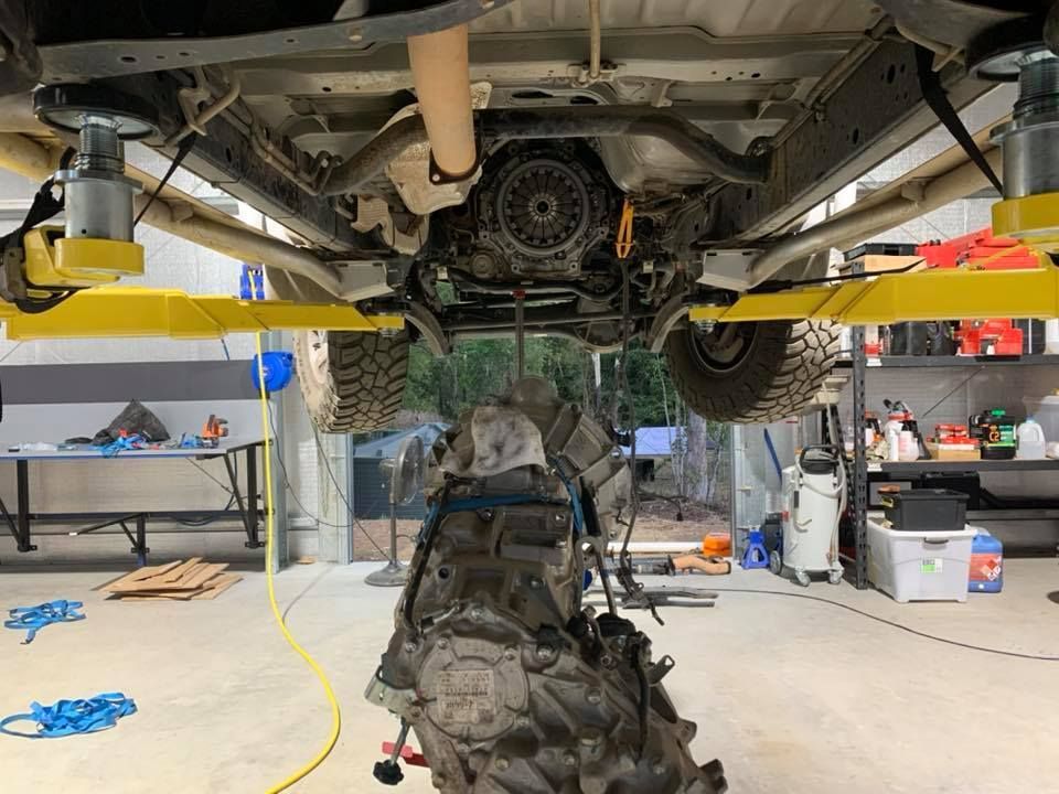 A Car Engine Is Being Removed From Underneath A Truck In A Garage — Dieselflash Whitsundays in Airlie Beach, QLD