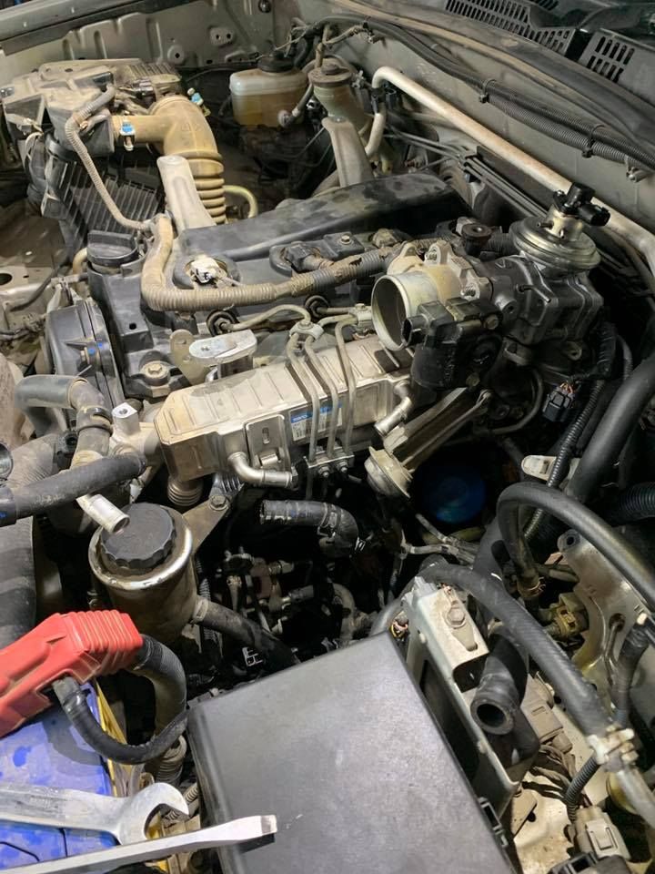 A Close Up Of A Car Engine With A Wrench And A Battery — Dieselflash Whitsundays in Proserpine, QLD