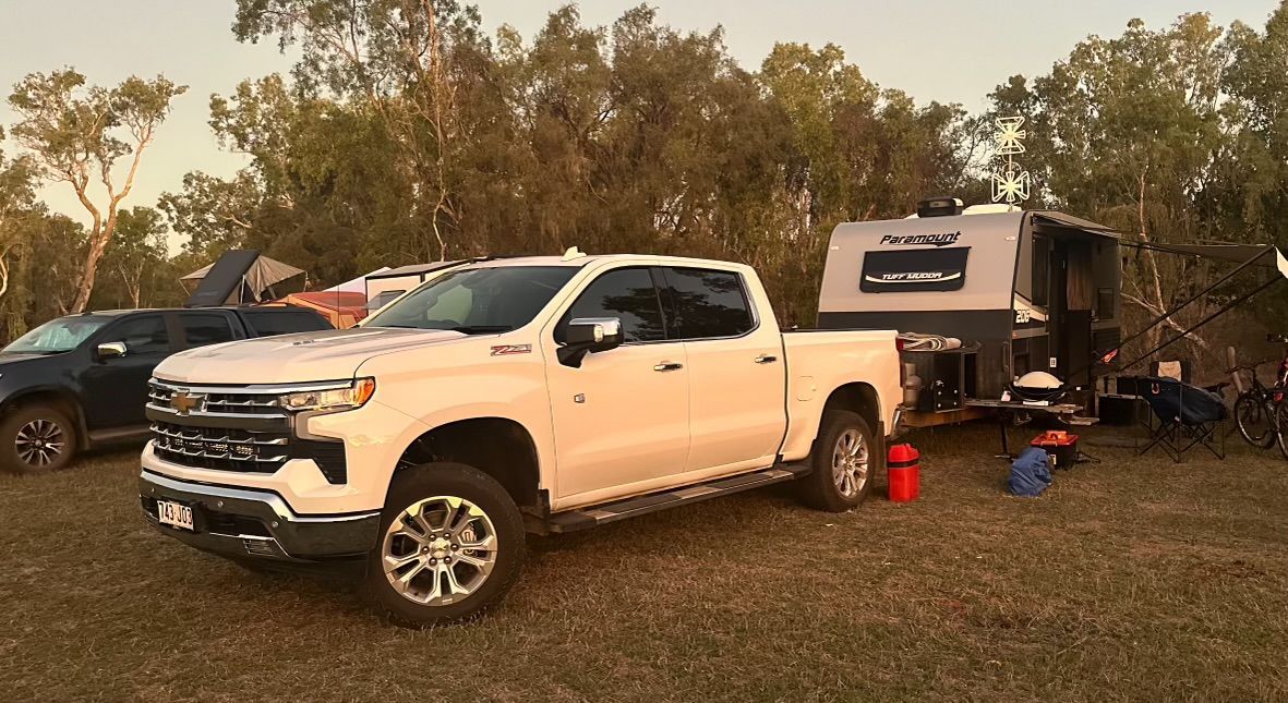 A White Truck is Parked Next to a Trailer in a Field — Dieselflash Whitsundays in Mackay, QLD