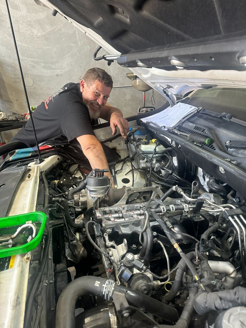 A Man is Working on the Engine of a Car — Dieselflash Whitsundays in Proserpine, QLD