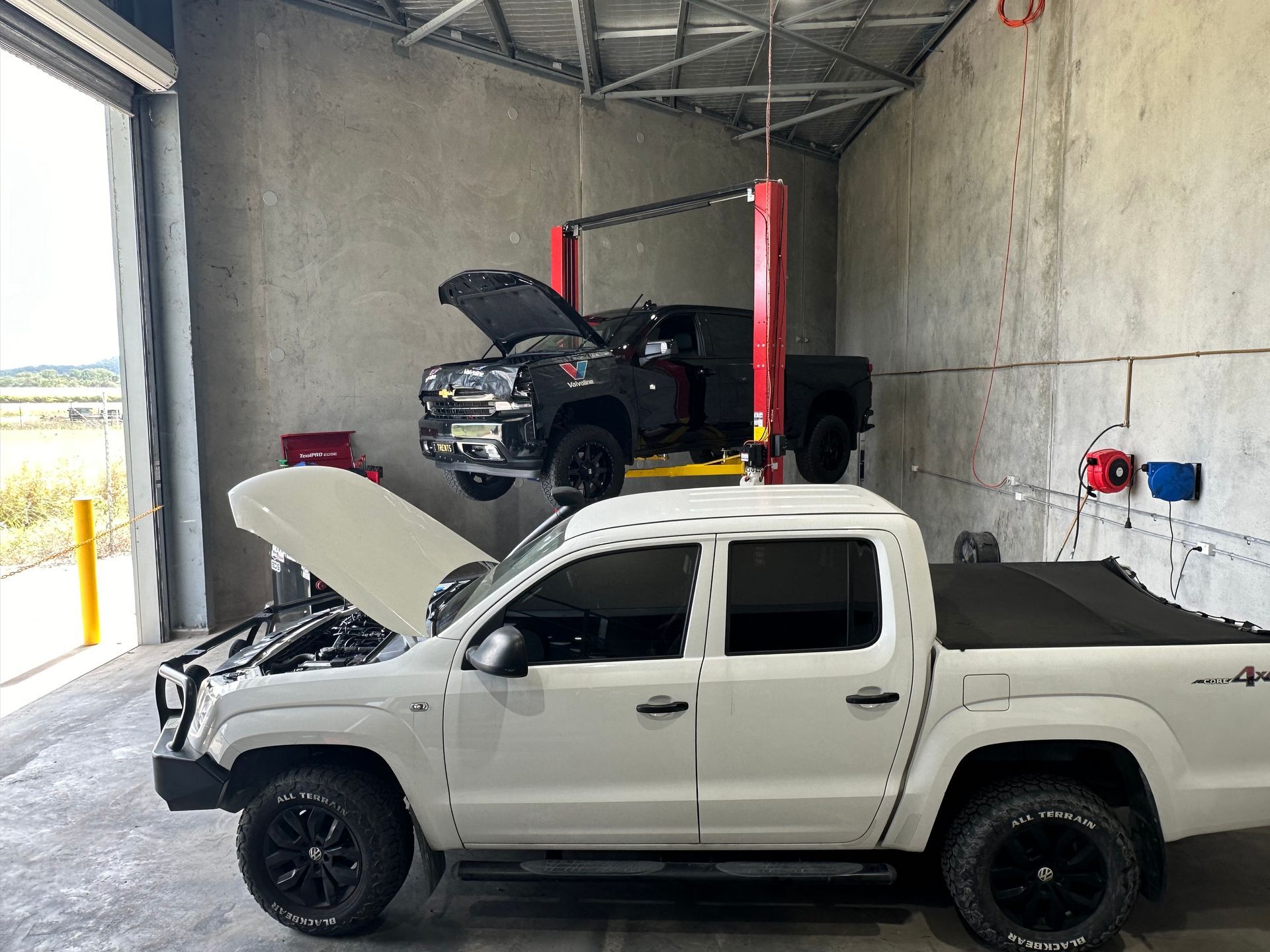A White Truck is Parked in a Garage With Its Hood Open — Dieselflash Whitsundays in Airlie Beach, QLD