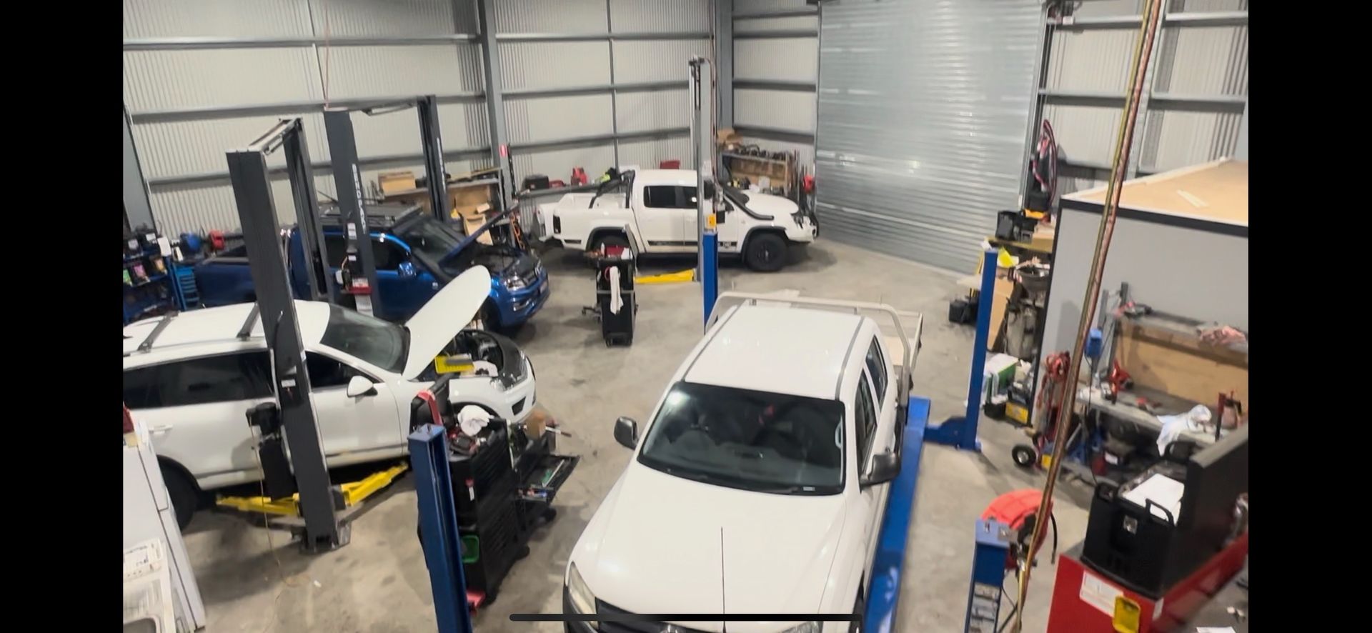 A Garage Filled With Cars and Trucks on Lifts — Dieselflash Whitsundays in Proserpine, QLD