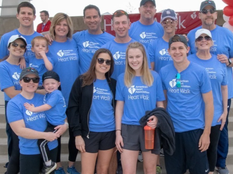 A group of people wearing blue shirts that say heart walk