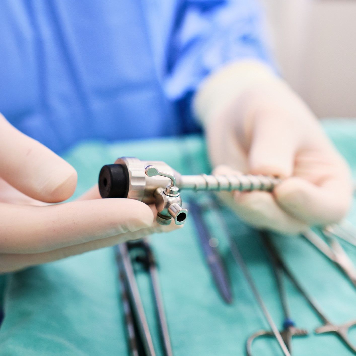 A surgeon is holding a surgical tool in his hands. A surgeon is holding a surgical tool in his hands.