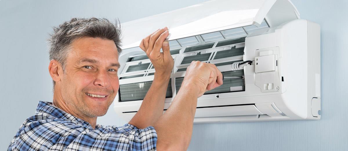 Male Technician Repairing Air Conditioner — Sewickley, PA — Sta So Cool HVAC Male Technician Repairing Air Conditioner — Sewickley, PA — Sta So Cool HVAC