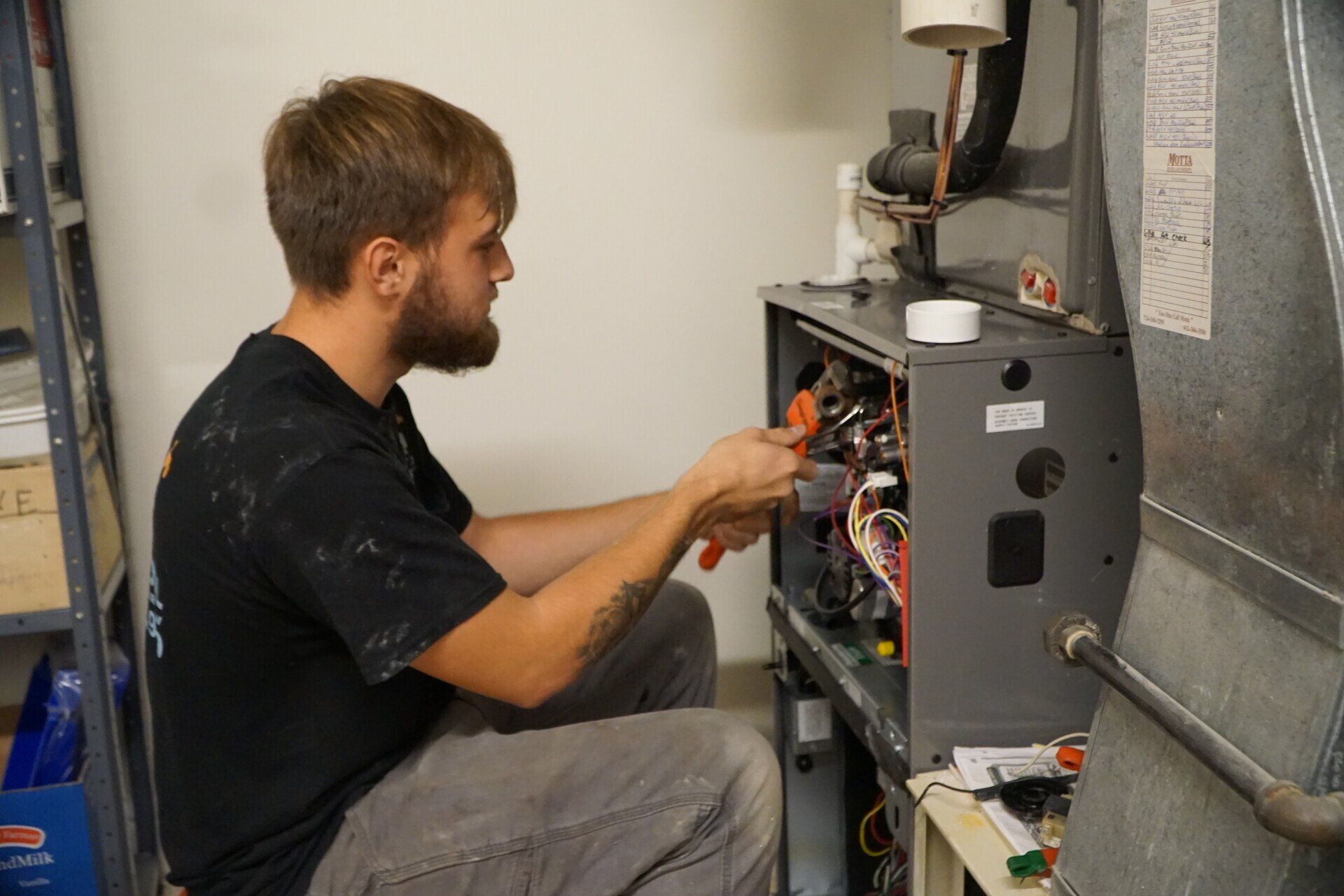 Worker Installing Air Conditioner — Sewickley, PA — Sta So Cool HVAC A technician working on an air conditioning repair in Cranberry Township, PA