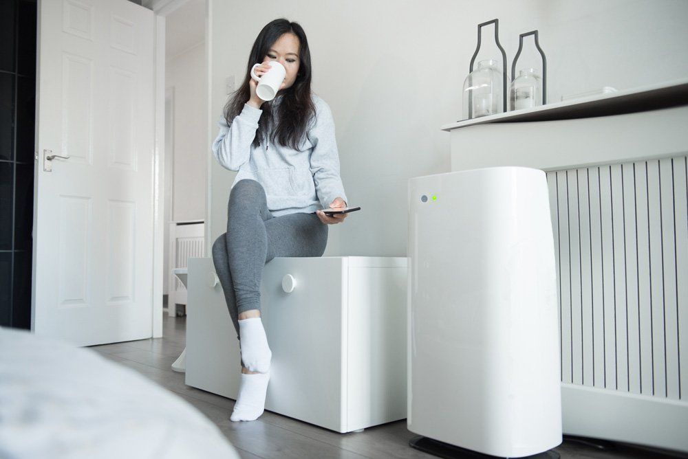 Woman Controls the Power of Her Smart Air Unit — Sewickley, PA — Sta So Cool HVAC Woman Controls the Power of Her Smart Air Unit — Sewickley, PA — Sta So Cool HVAC