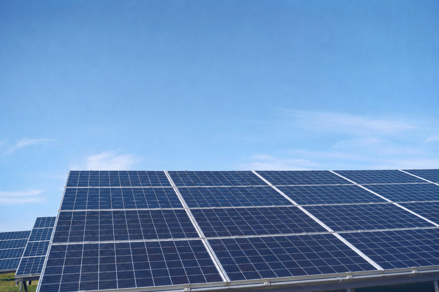 Solar panels against a clear blue sky.