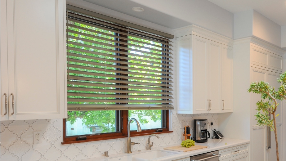 a kitchen with white cabinets , a sink , and a window with blinds All Window Decor (817) 448-3393.