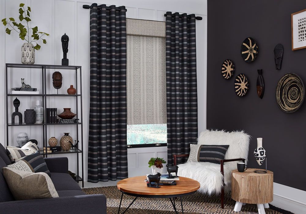 a living room with a couch , chair , coffee table and a window with shades and drapery All Window Decor (817) 448-3393.