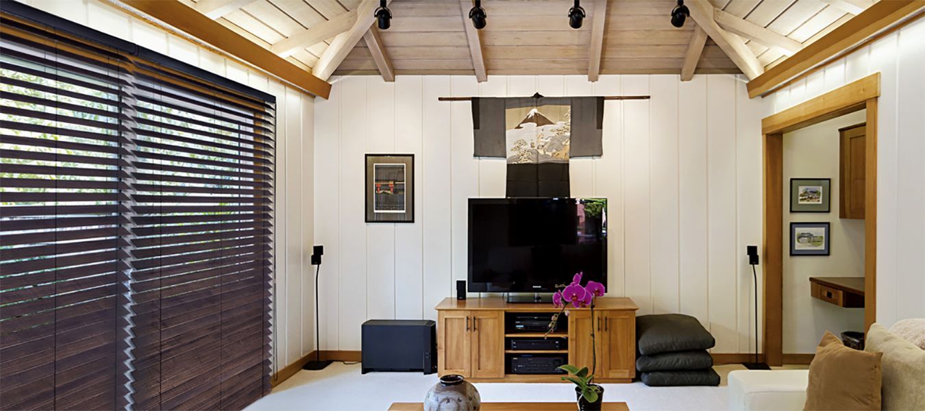 a living room with a flat screen tv on the wall All Window Decor (817) 448-3393