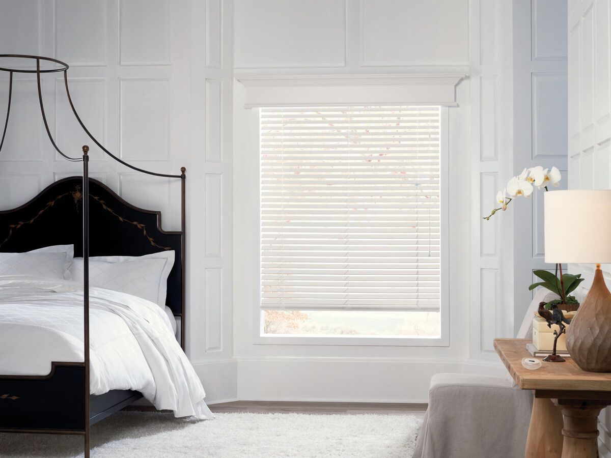 a bedroom with a canopy bed and a window with blinds All Window Decor (817) 448-3393.