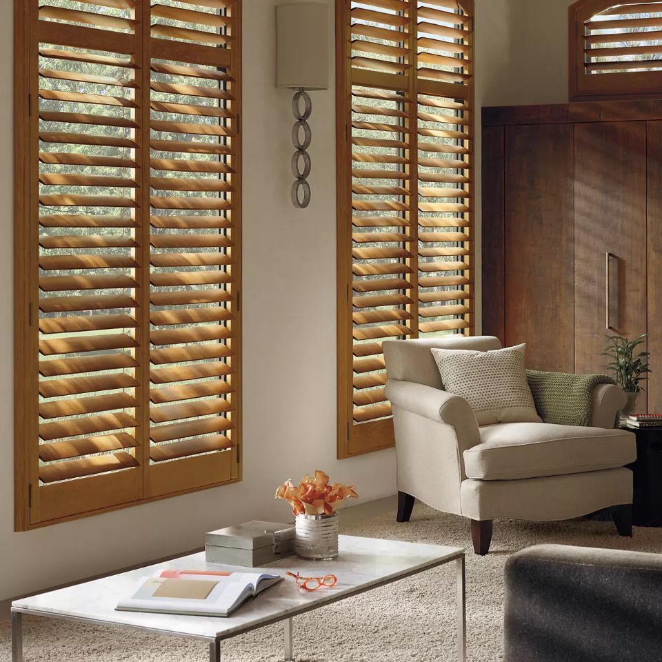 a living room with wooden shutters on the windows All Window Decor (817) 448-3393