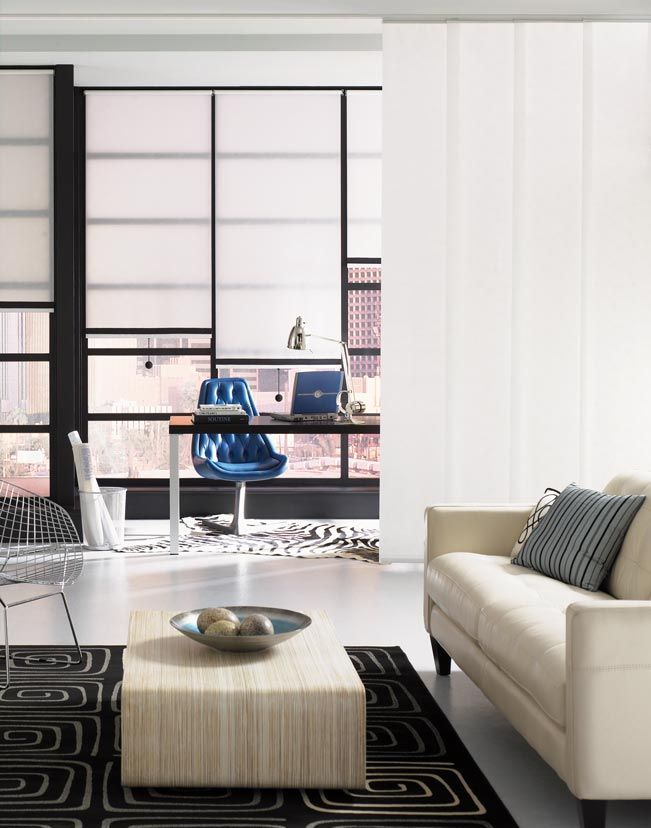 a living room with a couch and a coffee table with roller shades All Window Decor (817) 448-3393