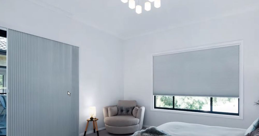 a bedroom with a bed , chair and window with honeycomb shades All Window Decor (817) 448-3393.