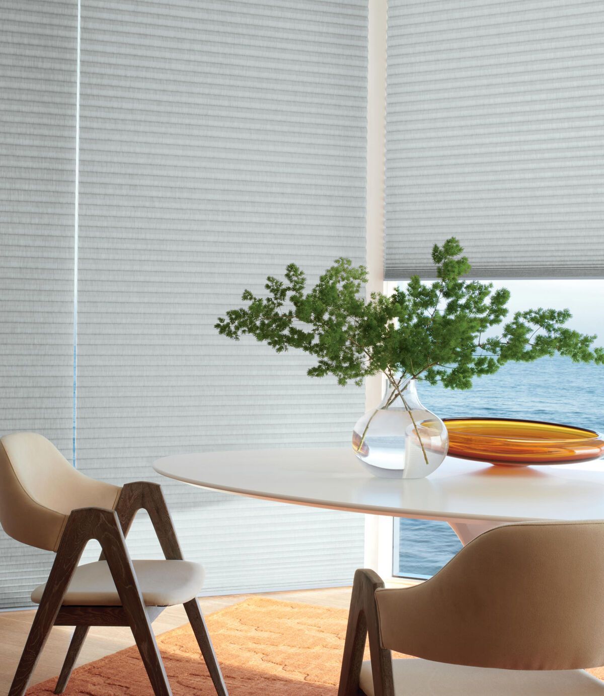 a dining room with a table and chairs and a vase of flowers on it with honeycomb shades All Window Decor (817) 448-3393.