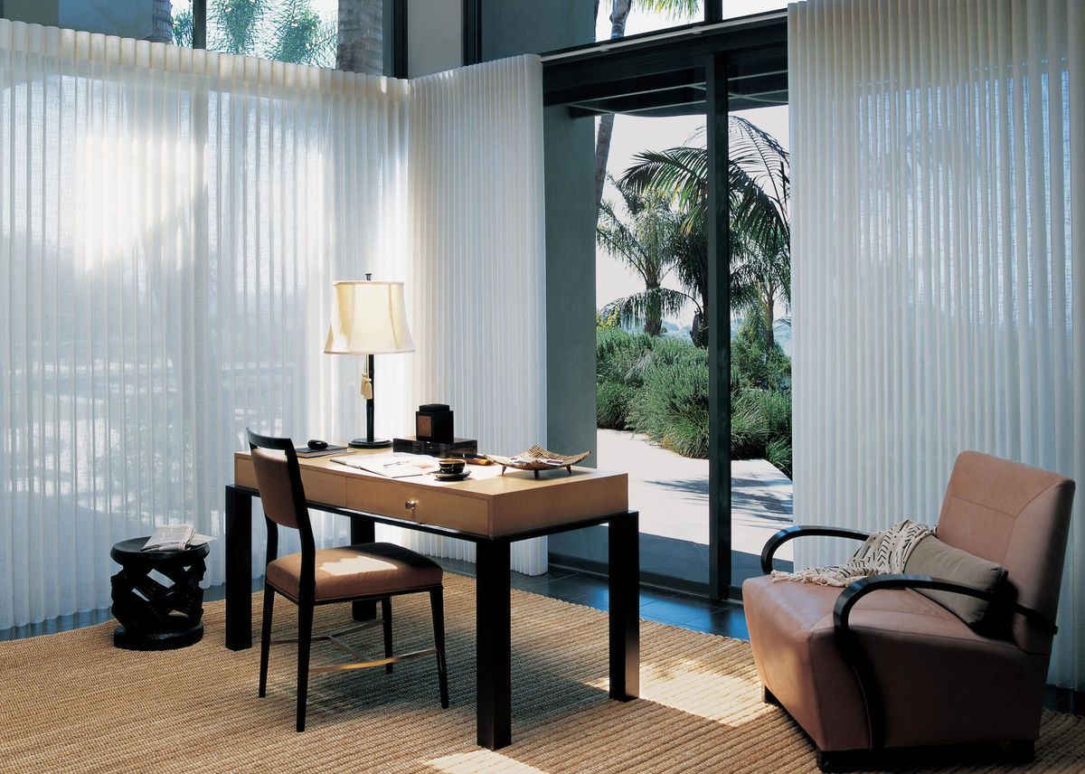a living room with a couch , chair , lamp and white shutters All Window Decor (817) 448-3393.