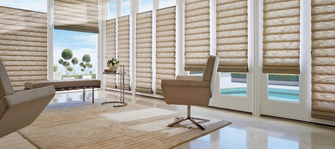 a living room with a chair and a table and lots of windows All Window Decor (817) 448-3393.
