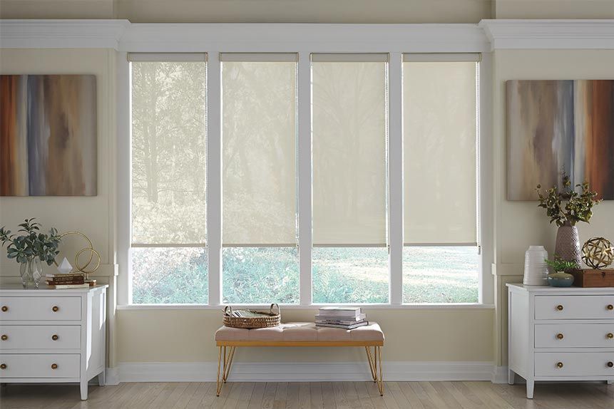 a living room with a bench in front of a window with roller shades All Window Decor (817) 448-3393.