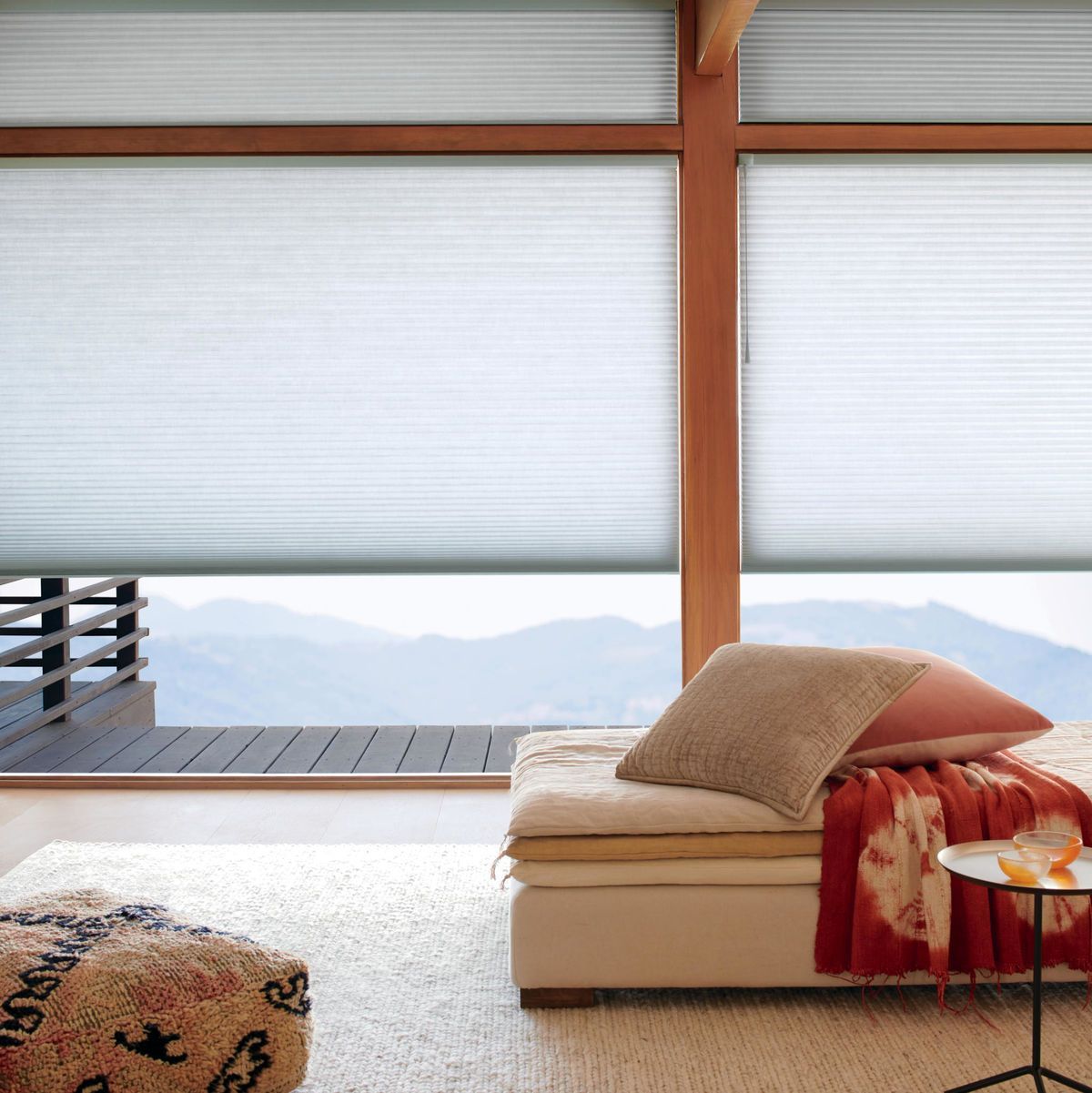 a living room with a large window and a couch and honeycomb shades All Window Decor (817) 448-3393