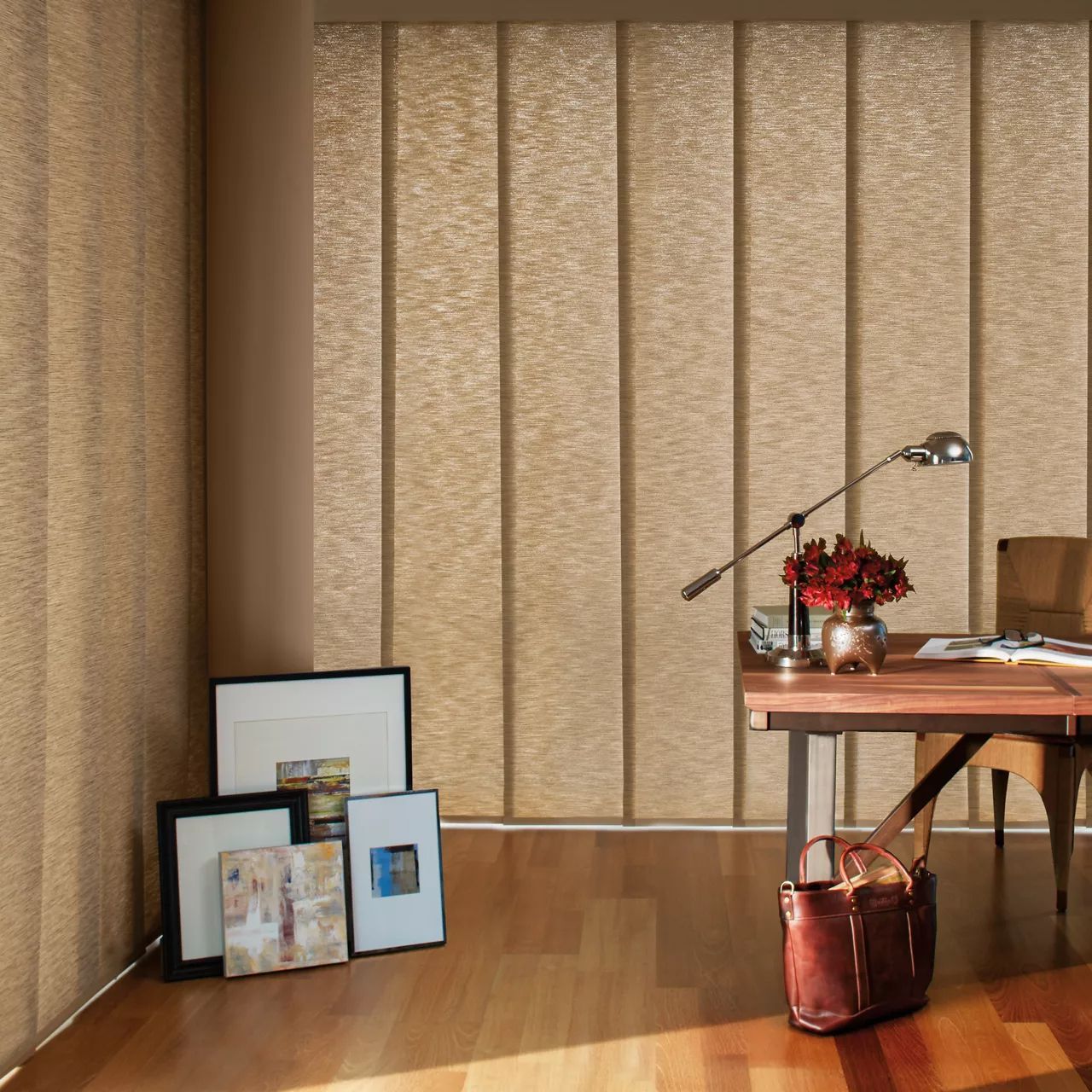 a room with a desk and chair and a lamp and panel track shades All Window Decor (817) 448-3393